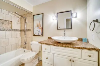 a bathroom with a sink and a toilet and a tub at Half-Mi to Riverwalk Charming Sanford Retreat! in Sanford