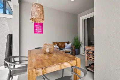 a dining room with a wooden table and chairs at 5003 Windermere Avenue in Kissimmee