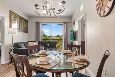 a dining room and living room with a table and chairs at 4802 Cayview Avenue 308 in Orlando
