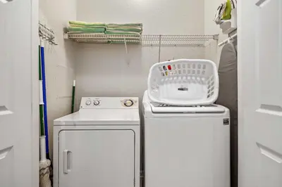 a small laundry room with a washer and dryer at 4802 Cayview Avenue 308 in Orlando