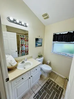 a bathroom with a sink and a toilet at 43 Vacation Home With Private Pool Located At Formosa Gardens!! in Orlando