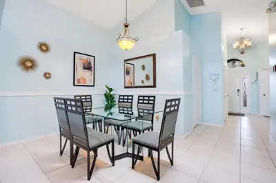 a dining room with a table and chairs at Relaxing Retreat with Pool and Movie Theater in Orlando