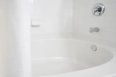 a white bath tub with a faucet in a bathroom at Stylish Villa Near Disney & Universal in Kissimmee