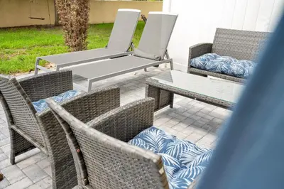 a group of chairs and tables on a patio at Stylish Villa Near Disney & Universal in Kissimmee