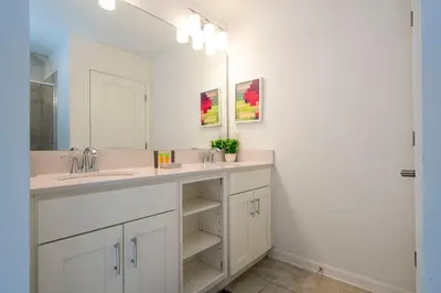 a bathroom with a sink and a mirror at Stylish 2-BR Apt Sleeps 7 Near Disney Magic in Kissimmee