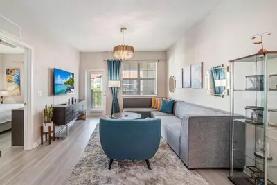 a living room with a couch and a table at Modern Resort 2BR near Icon park, Convention center and NEW Epic Universe in Orlando