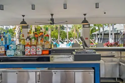a bar with a lot of bottles of alcohol at Modern Resort 2BR near Icon park, Convention center and NEW Epic Universe in Orlando