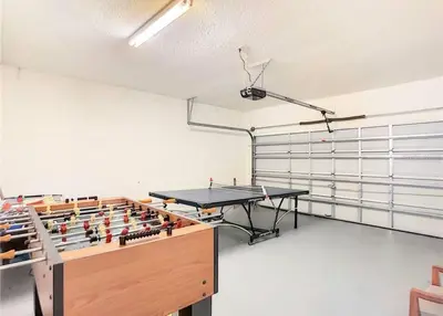 a room with a ping pong table in it at 7BD 5BA w Pool Spa Home 10 mins away to Disney in Kissimmee