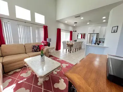 a living room with a couch and a table at Sunkey Disney Home Resort 10 min from the Parks in Kissimmee