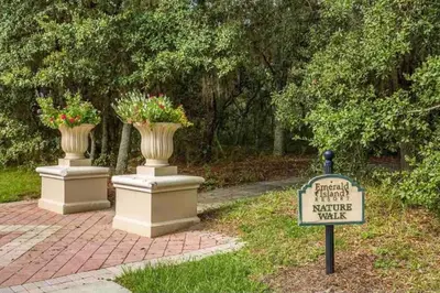 a park with two vases and a sign in the grass at Sunkey Disney Home Resort 10 min from the Parks in Kissimmee