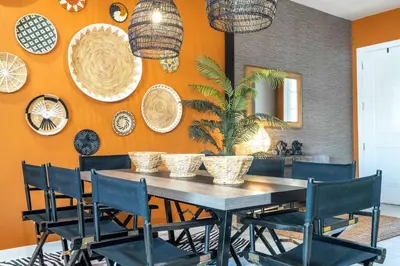 a dining room with a table with chairs and plates on the wall at Welcome to The Lion Nest. A Savanna-Inspired Oasis in Orlando