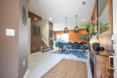 a hallway with a dining room with a table at Welcome to The Lion Nest. A Savanna-Inspired Oasis in Orlando