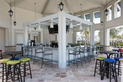 a bar in a pavilion with chairs and tables at Storey Lake *10 mim -> Disney* 4Q/3Ba in Kissimmee