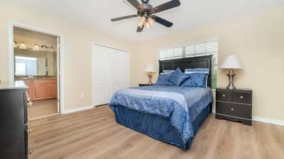 a bedroom with a bed and a ceiling fan at Storey Lake *10 mim -> Disney* 4Q/3Ba in Kissimmee