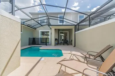 a house with a swimming pool with a glass ceiling at Casa luxuosa 4BD/3BA * Storey Lake * in Kissimmee