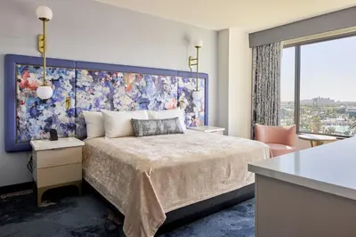 a bedroom with a large bed and a large window at Universal's Helios Grand Hotel, a Loews Hotel in Orlando
