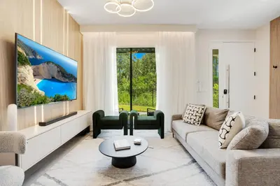a living room with a couch and a tv at Luxury Villa Near Disney and Universal in Kissimmee