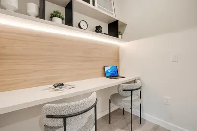 a room with a desk with two chairs and a laptop at Luxury Villa Near Disney and Universal in Kissimmee