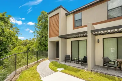 a house with a balcony with a table and chairs at Luxury Villa Near Disney and Universal in Kissimmee