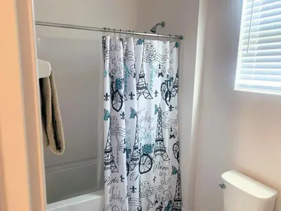 a bathroom with a shower with a shower curtain at Magic Kingdom Villa - Private Master Bedrooms in Kissimmee