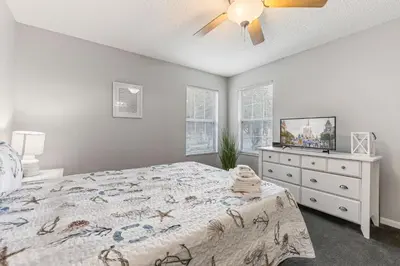 a bedroom with a bed and a ceiling fan at 6 Bedroom Villa - Emerald Island Retreat in Kissimmee