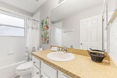 a bathroom with a sink and a toilet at 6 Bedroom Villa - Emerald Island Retreat in Kissimmee