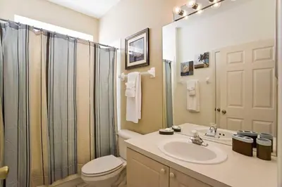 a bathroom with a toilet and a sink and a shower at Just 3 miles from Disney! in Kissimmee