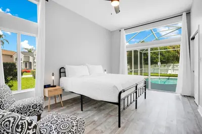 a bedroom with a bed and a large window at Luxury Villa Near Disney I Fully Renovated in Kissimmee