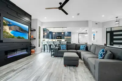 a living room with a couch and a flat screen tv at Luxury Villa Near Disney I Fully Renovated in Kissimmee