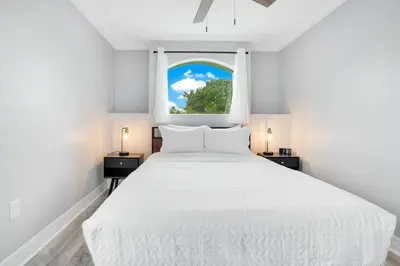 a bedroom with a white bed and a window at Luxury Villa Near Disney I Fully Renovated in Kissimmee