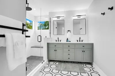 a bathroom with a sink and two mirrors at Luxury Villa Near Disney I Fully Renovated in Kissimmee