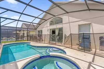 an indoor swimming pool with a glass ceiling and a building at Summer Getaway - 5-Bedroom Home with Private Pool! in Kissimmee