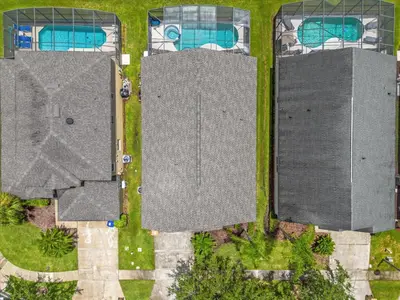 an overhead view of three roofs with swimming pools at Summer Getaway - 5-Bedroom Home with Private Pool! in Kissimmee