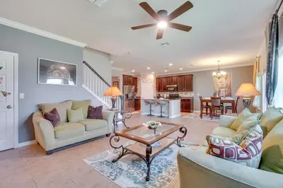 a living room with two couches and a table at WFH, Relax and Enjoy At-Home Comforts in Orlando in Kissimmee