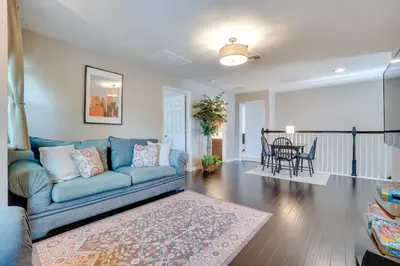 a living room with a blue couch and a table at WFH, Relax and Enjoy At-Home Comforts in Orlando in Kissimmee