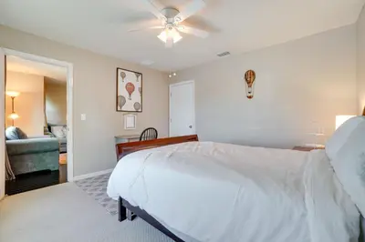 a bedroom with a bed and a ceiling fan at WFH, Relax and Enjoy At-Home Comforts in Orlando in Kissimmee