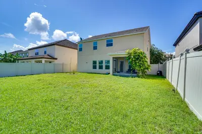 a yard in front of a house with a fence at WFH, Relax and Enjoy At-Home Comforts in Orlando in Kissimmee