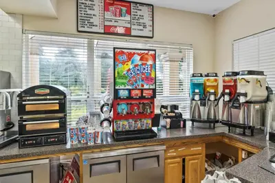 a kitchen with a counter top with a coffee shop at Wheelchair-Friendly Villa Near Disney World in Orlando