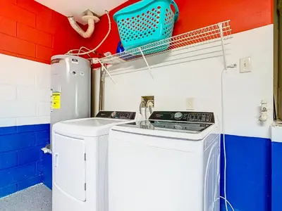 a laundry room with a washer and dryer at Dreamy 5BR, 3Bath Getaway, Pool, Spa, Near Disney in Orlando