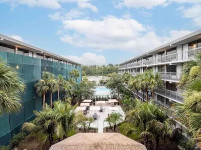 an aerial view of the courtyard of a resort with palm trees at Orlando 1BR Relaxing Condo Next to Disney With Pool view in Kissimmee