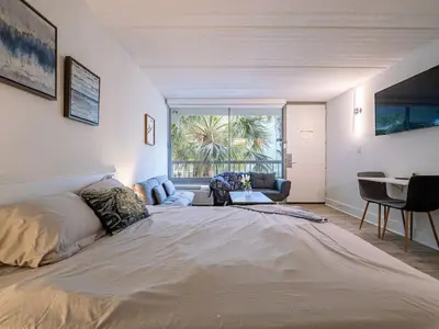 a large bed in a room with a large window at Orlando 1BR Relaxing Condo Next to Disney With Pool view in Kissimmee