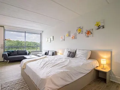 a bedroom with a large bed and a large window at Luxury Orlando Condo Next to Disney with lake view in Kissimmee