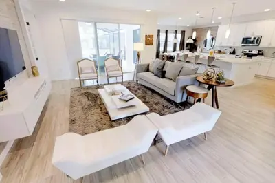 a living room with a couch and a table at 3841 Kalistoga Stylish Villa 7BD Private Pool and Game Room in Kissimmee