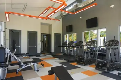 a gym with a lot of treadmills and ellipticals at 3841 Kalistoga Stylish Villa 7BD Private Pool and Game Room in Kissimmee