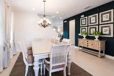 a dining room with a white table and chairs at 7738-IBRHAIM · 7738 Fairfax Dream Home in Orlando