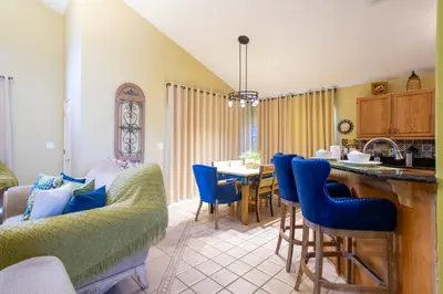 a kitchen and dining room with a table and chairs at Celebrate BR in Orlando