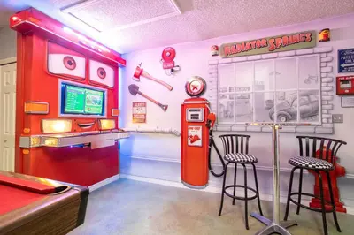 a room with an old gas station and two stools at Celebrate BR in Orlando
