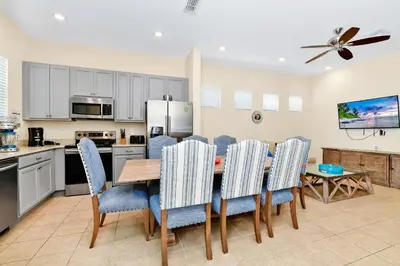 a kitchen and dining room with a table and chairs at Ocean Blue Cottage Near Disney With Private Hot Tub & Margaritaville Resort & Island H20 Waterpark Access - 3012Sr in Orlando