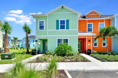 an orange and green house with palm trees at Serene Villa Near Disney With Margaritaville Resort & Island H20 Access - 8147Cp in Orlando
