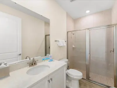 a bathroom with a toilet sink and a shower at Sunshine Villa Near Disney With Margaritaville Resort & Island H20 Waterpark Access - 2922Cl in Orlando